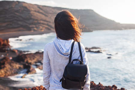 Traveler woman enjoy scenic ocean beach. Vacation conceptの写真素材