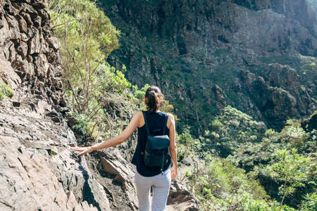 Hiking woman in the mountains. Masca valley, Tenerife, Canary islands, Spain. Active vacation conceptの写真素材