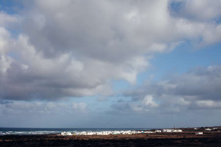 Dramatic sky over ocean and city in Lanzarote island. Travel destination