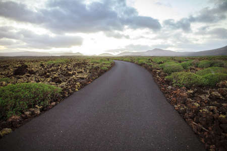 Empty road and unique Lanzarote landscape. Travel backgroundの写真素材