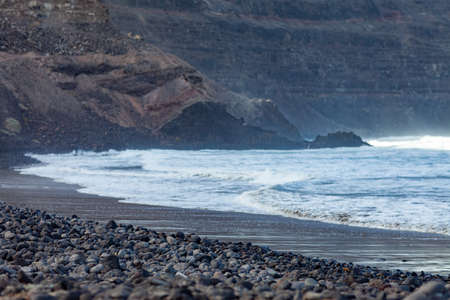 Black volcanic beach and ocean landscape. Playa De Orzola on Lanzarote, Canary Islands, Spain. Seascape backgroundの写真素材