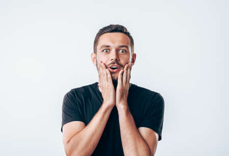 Portrait of young surprised man. People emotion facial expressionの写真素材