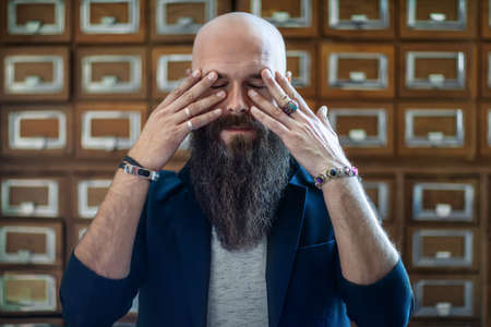 Dramatic portrait of tired bearded hipster man in stress. Depression conceptの写真素材