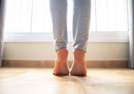 Woman bare feet walking on floor, closeup.の写真素材