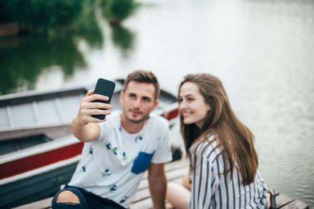 Young beautiful couple taking selfie on romantic picnicの写真素材