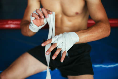 Boxer man is wrapping hands with boxing wraps. Boxing conceptの写真素材