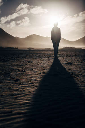 Lonely woman in desert. Mystery concept
