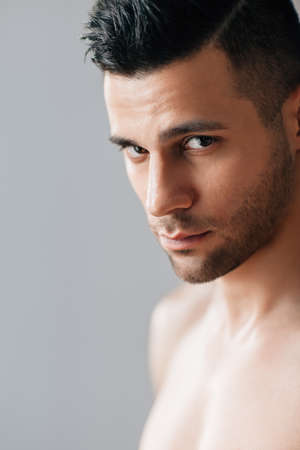 Close up portrait of handsome shirtless man in studio