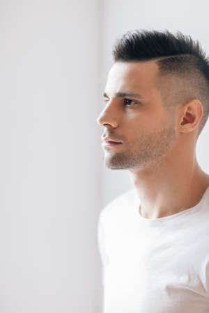 Handsome young man profile portrait in studioの写真素材