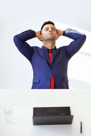 Happy businessman relaxing in office.  Success and relax concept の写真素材
