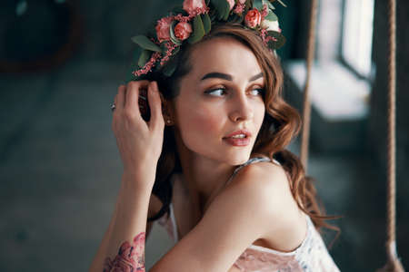 Sensual beautiful woman portrait with wreath of flowers in her hair. Fashion concept                                                                      の写真素材