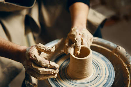 Potter modeling ceramic pot from clay on a potter's wheel. Workshop, art conceptの写真素材