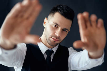 Handsome elegant man looking through a finger frame