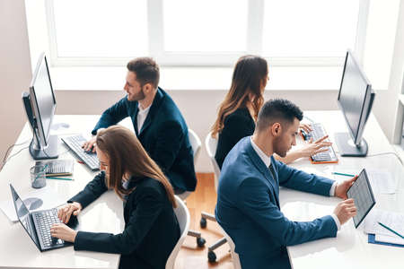 Top view of business people working on computer in modern officeの写真素材