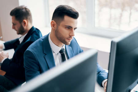 Young business man working on computer in his workplaceの写真素材