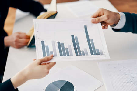 Business people showing business and financial report with increasing business graph