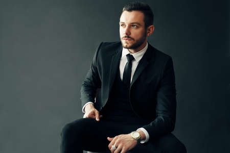 Elegant young man portrait on black backgroundの写真素材