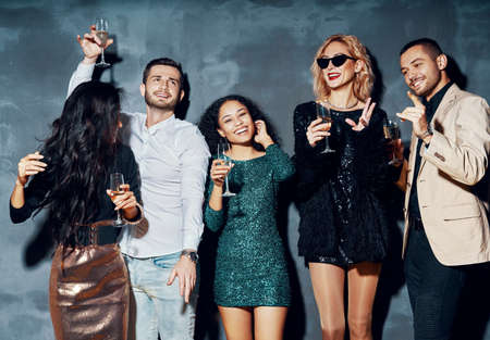 Diverse group of young people dancing in night club, enjoy party and have funの写真素材