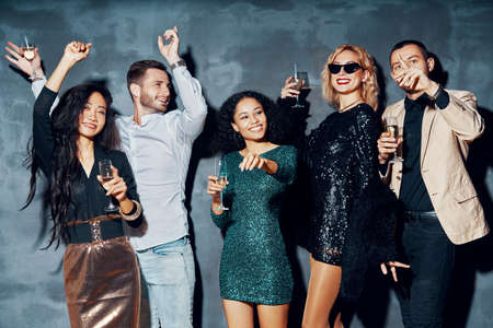 Diverse group of young people dancing in night club, enjoy party and have funの写真素材