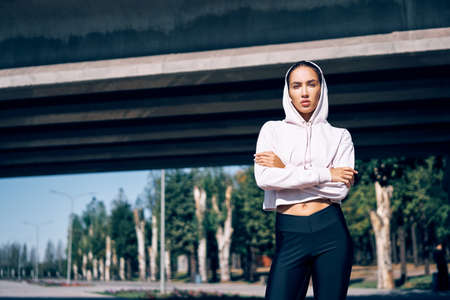Beautiful confident woman in sportswear posing outdoors. Beauty and sport conceptの写真素材