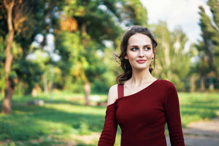 Portrait of young beautiful woman outdoors on green summer nature background. Female beauty conceptの写真素材