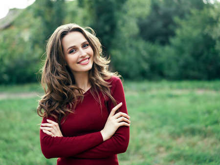 Portrait of young beautiful woman outdoors on green summer nature background. Female beauty conceptの写真素材