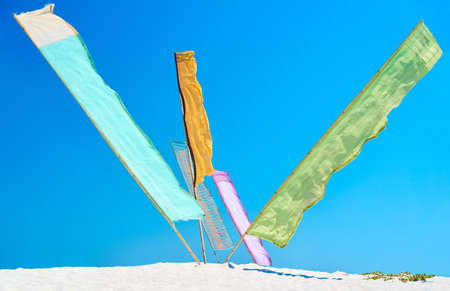Multicolor flags over blue sky background