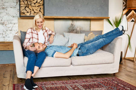 Young happy couple relax and enjoy each other at home