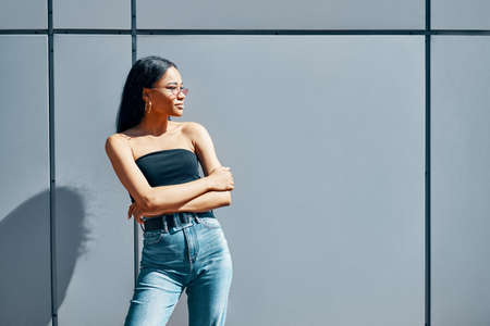 Stylish trendy african american woman posing on street wall urban backgroundの写真素材