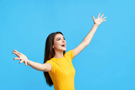 Excited happy girl standing with open arms
