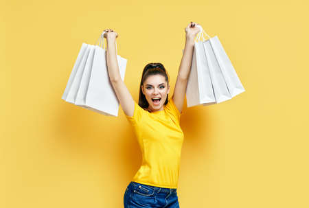 Happy excited shopaholic woman with shopping bags in hands enjoy her shoppingの写真素材