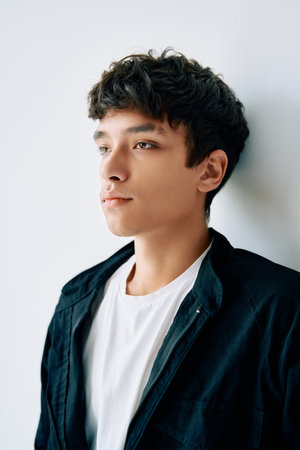 Close up portrait of young mixed race man on white studio backgroundの写真素材