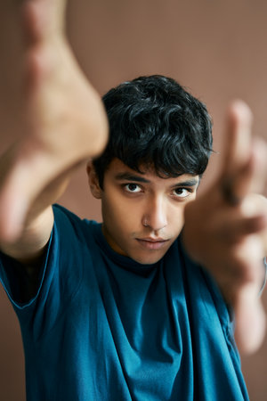 Attractive stylish young man reaching out hands to the cameraの写真素材