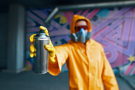 Graffiti artist pointing spray paint can to cameraの写真素材