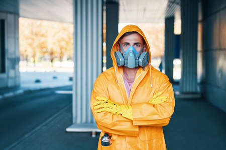 Close up portrait of young man in respirator mask posing on the streetの写真素材