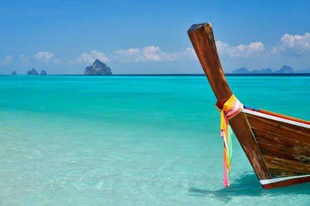 Wooden boat at tropical paradise beach with copy space