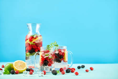 Fresh berries cocktails in glass jars and jug with copy spaceの写真素材