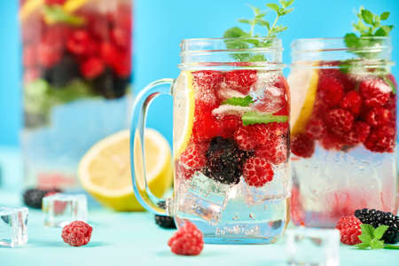 Fresh cocktail in glass jar on green backgroundの写真素材