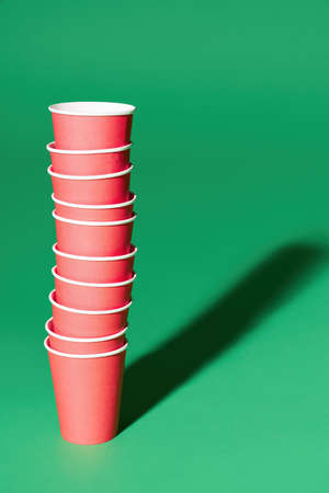 Stack of red paper cup on green backgroundの写真素材