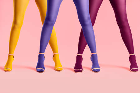 Long slim women legs in multi colored tights and stylish high heels shoesの写真素材