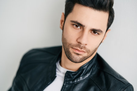 Closeup portrait of handsome thoughtful man posing on white studio backgroundの写真素材