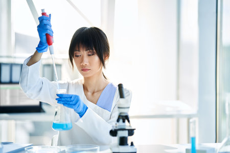 Asian scientist working in big modern laboratory doing some research