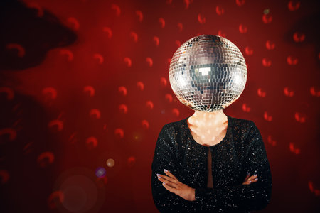 Woman in sequin dress with disco ball instead of headの写真素材