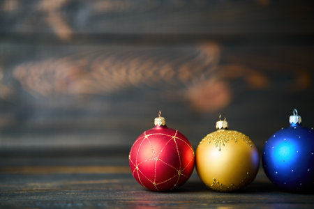 Christmas celebration holiday background. Colorful Christmas balls Christmas baubles on wooden background with copy spaceの写真素材