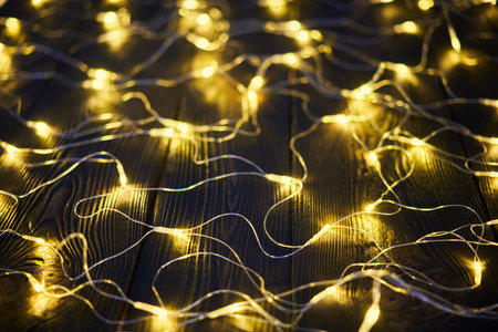 Christmas golden lights background. Merry Christmas and Happy New Year festive composition. Decorative garlandの写真素材