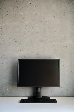 Computer monitor with blank black screen on the desk with copy space.