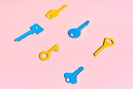 Various colorful keys on pink background. Flat layの写真素材