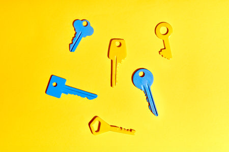 Colorful keys on yellow background. Flat layの写真素材