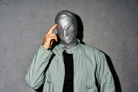 Mystery thoughtful man with duct tape face