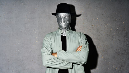 Mystery man with duct tape face wrap with crossed arms